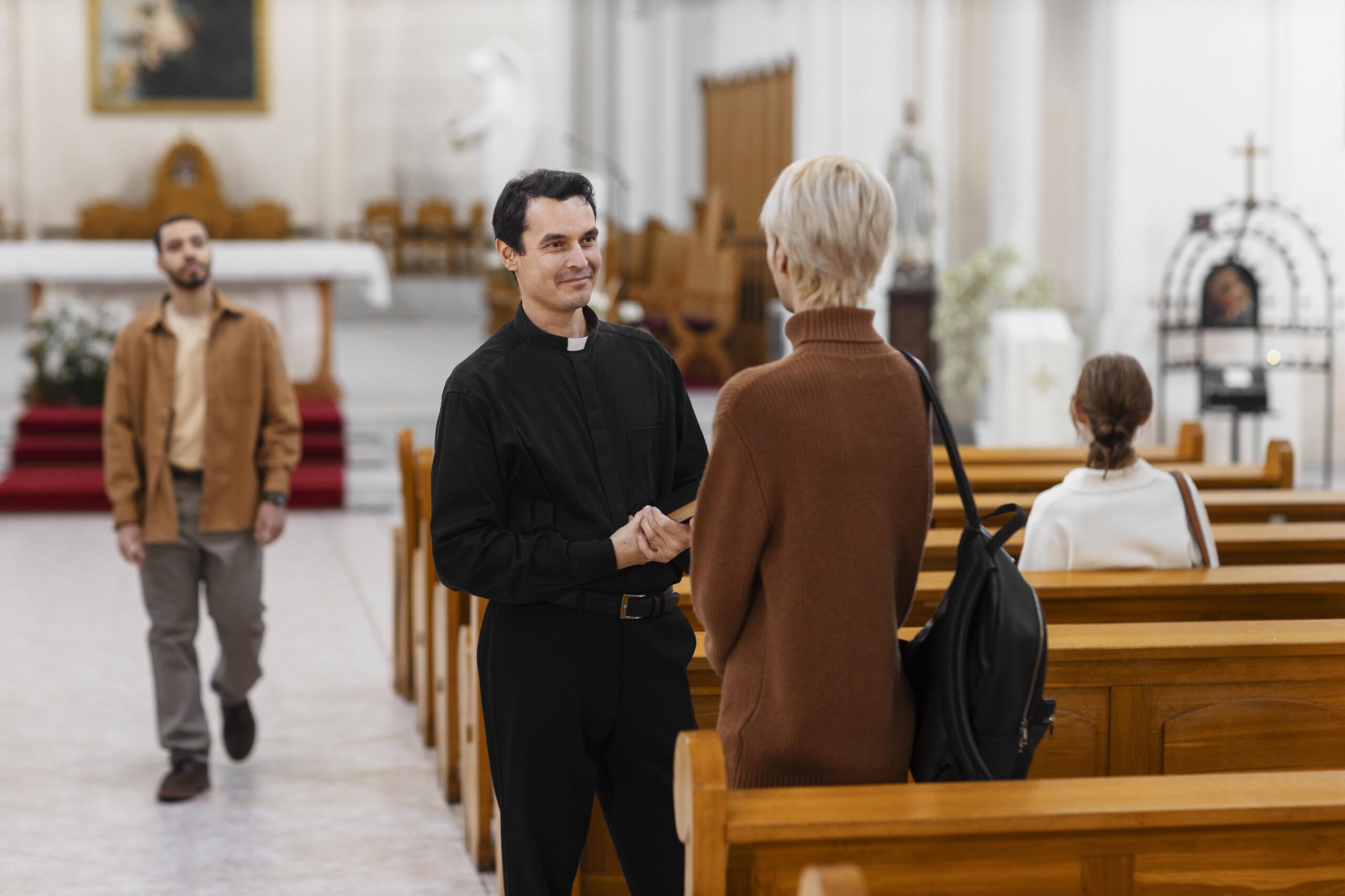 Priest greeting members of the congregation inside a church