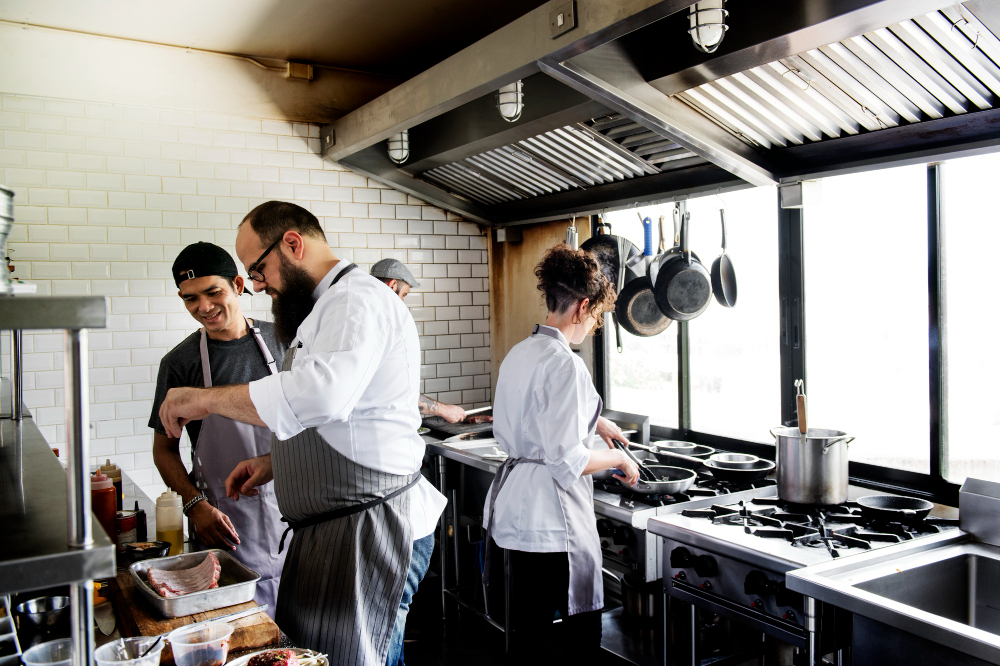 Chefs preparing dishes in a restaurant kitchen