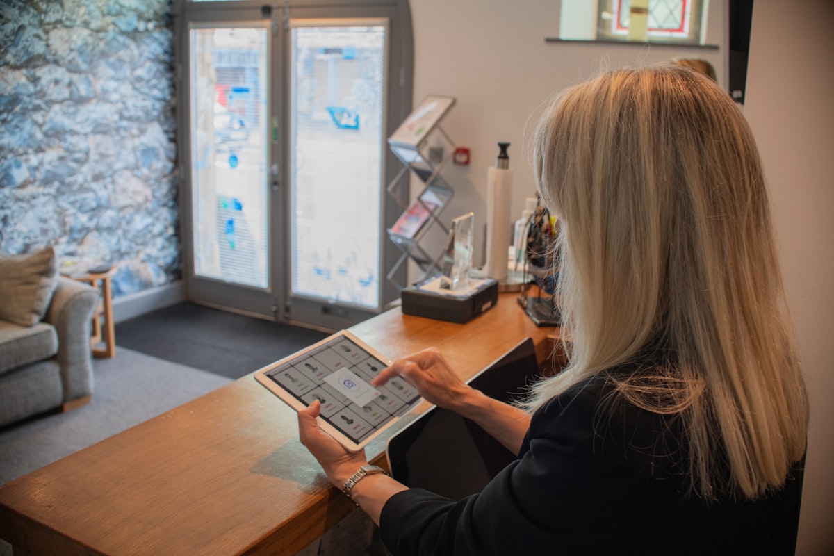 Gym owner reviewing tablet at front desk