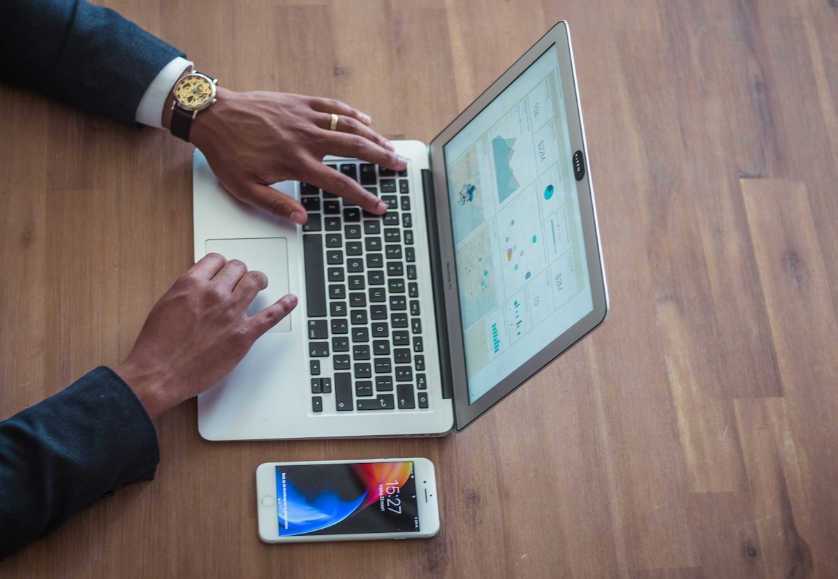 businessman reviewing revenue on laptop