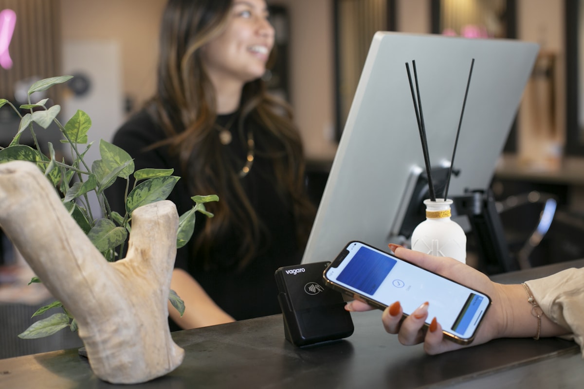 Customer scanning phone at checkout counter