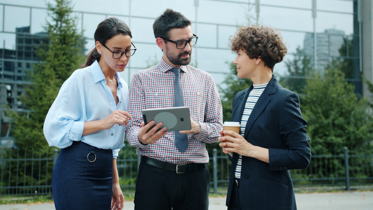 business team reviewing reports on tablet