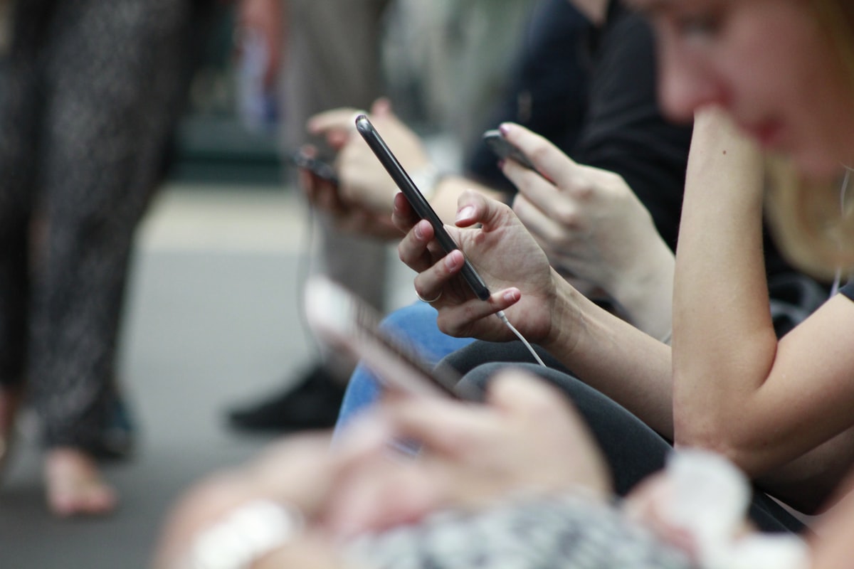 group of people looking at phones
