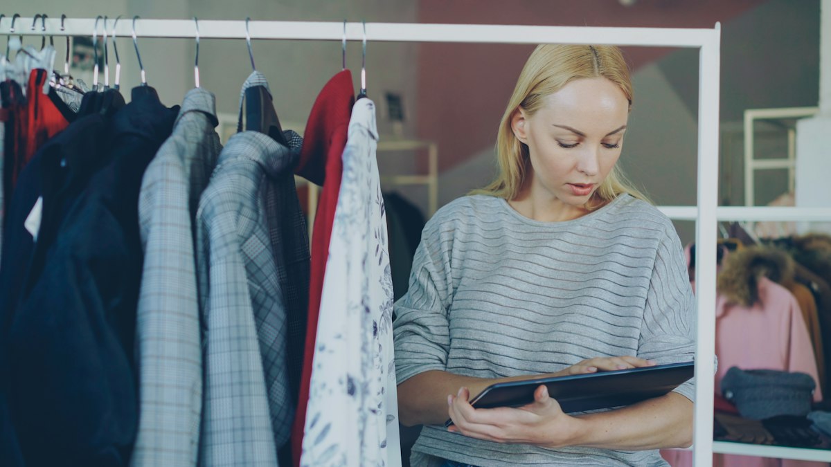Small business owner using tablet in retail store