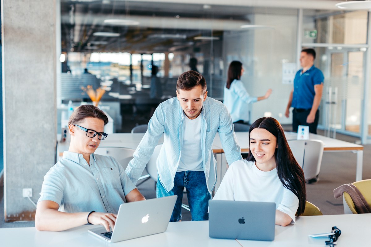 Business team reviewing app analytics on laptop